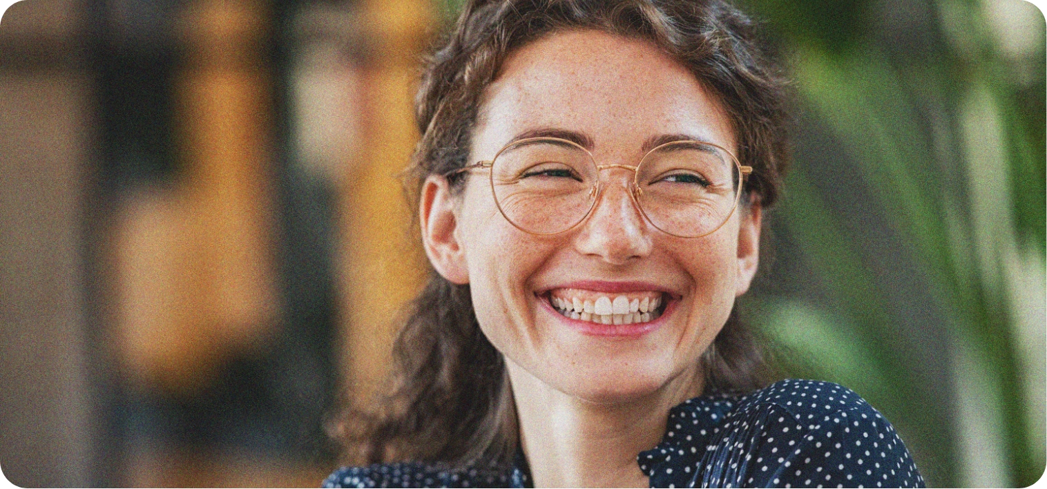 Woman smiles at something off camera as she discusses organisational culture.