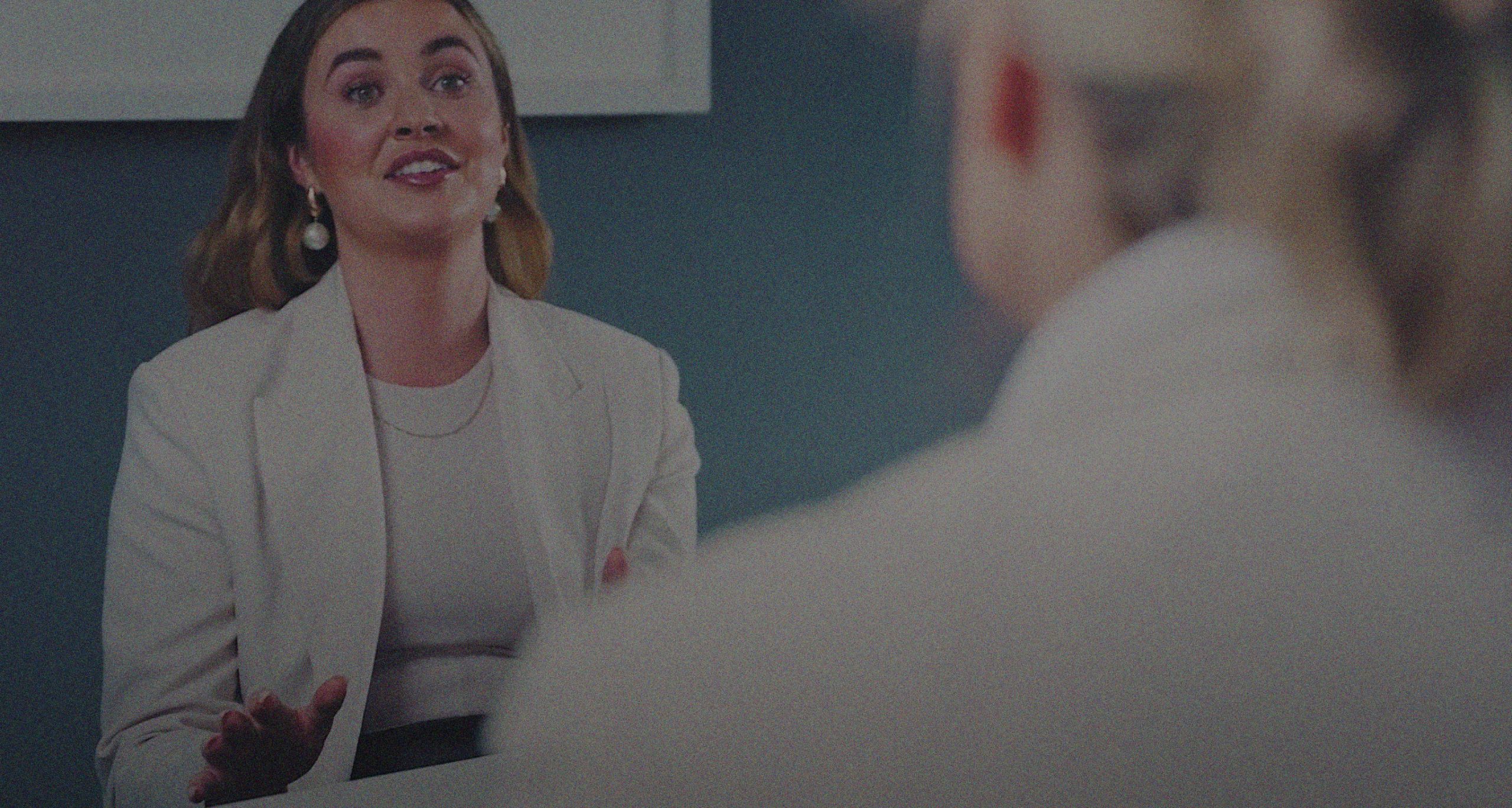 A woman smiles at another woman during a leadership and company culture coaching session.